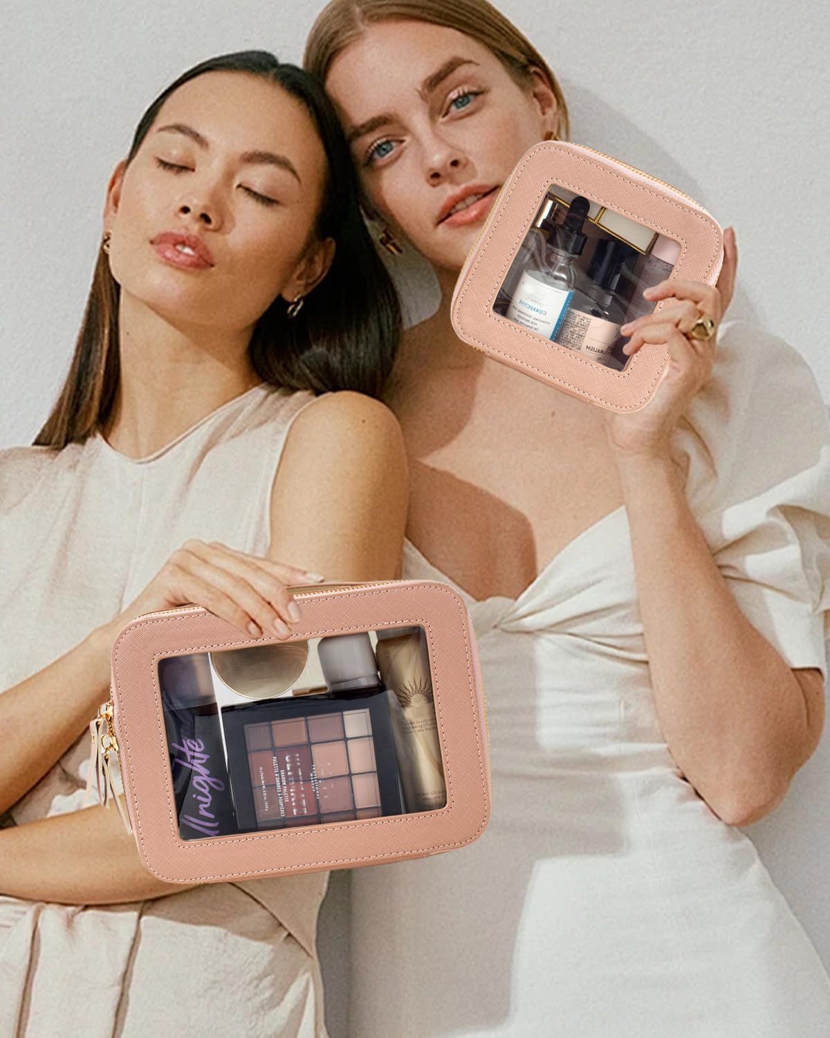 Two people holding dusty-pink clear-window makeup pouches