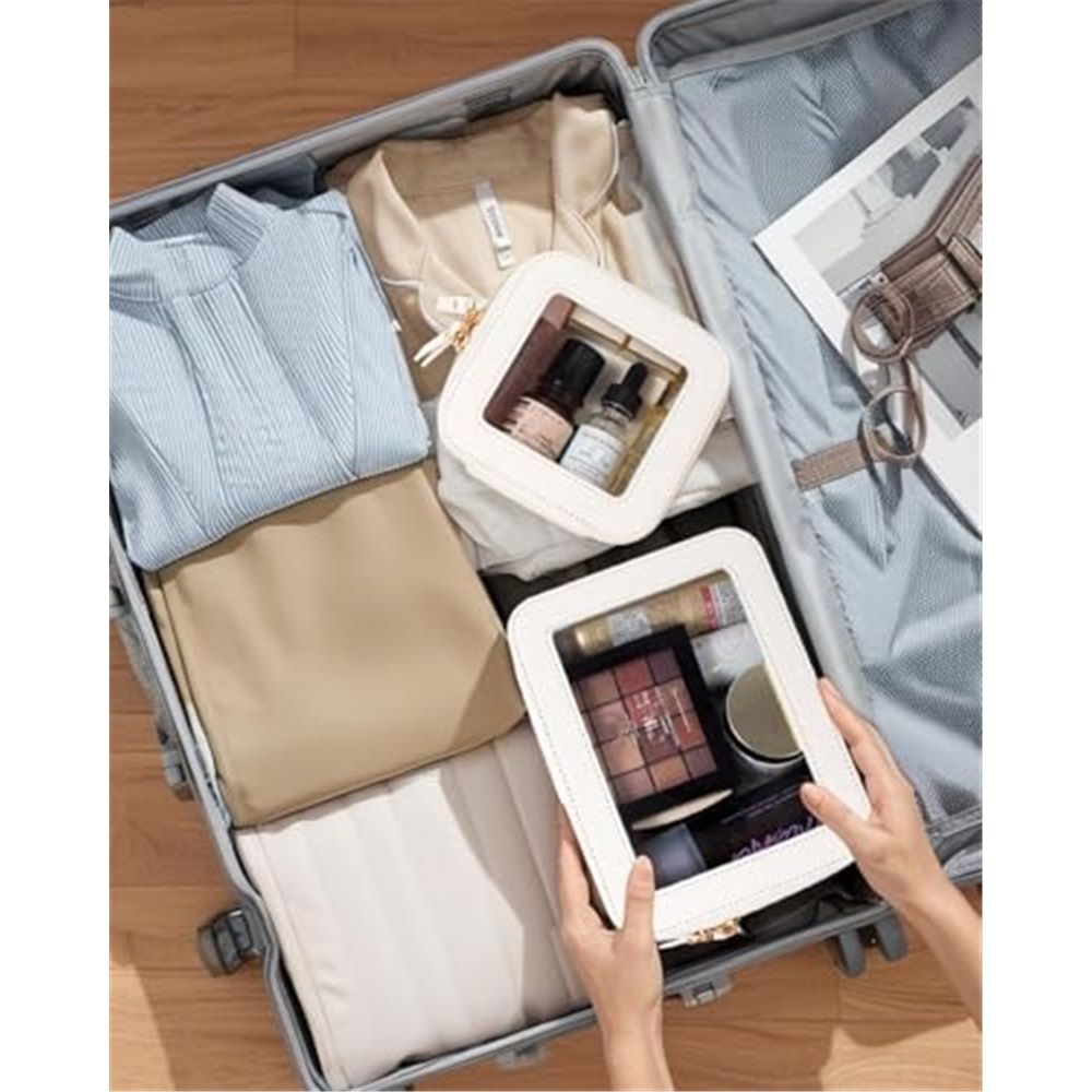 Cream pouches organising cosmetics in a suitcase