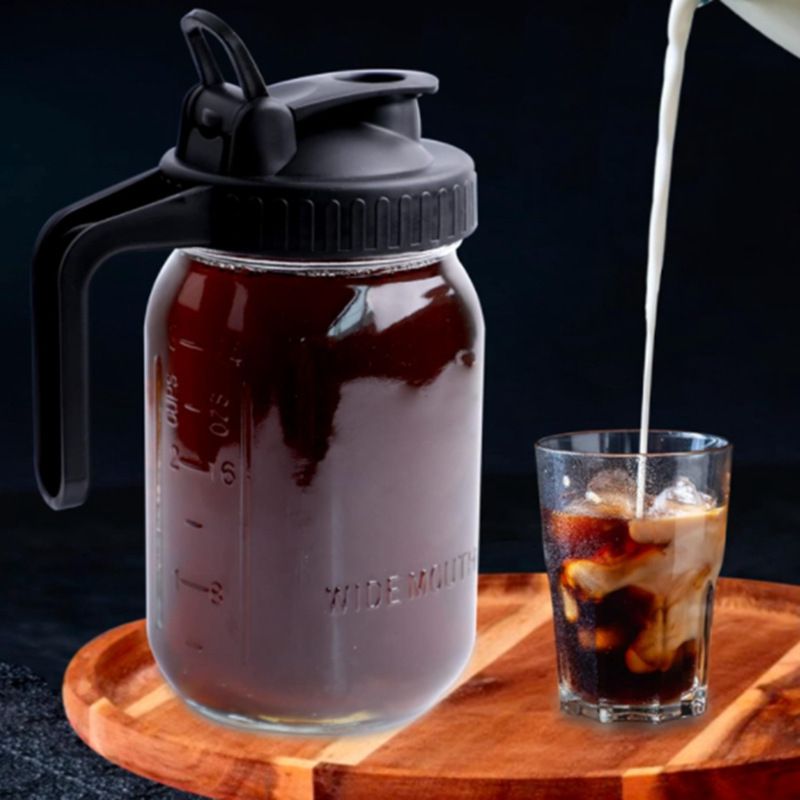 Glass cold brew pitcher pouring coffee over ice