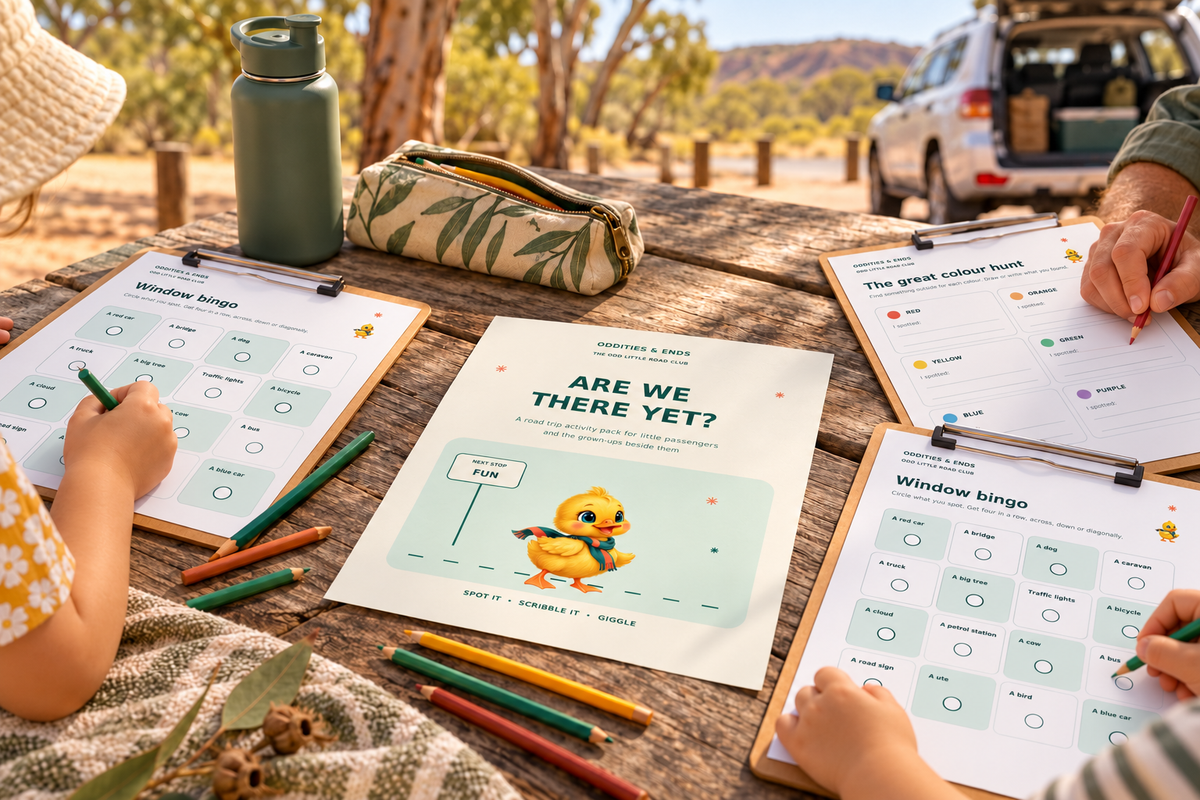 Styled scene of the Are We There Yet cover, Window Bingo and Colour Hunt printouts on a picnic table at a parked road trip stop; stationery and other props are not included
